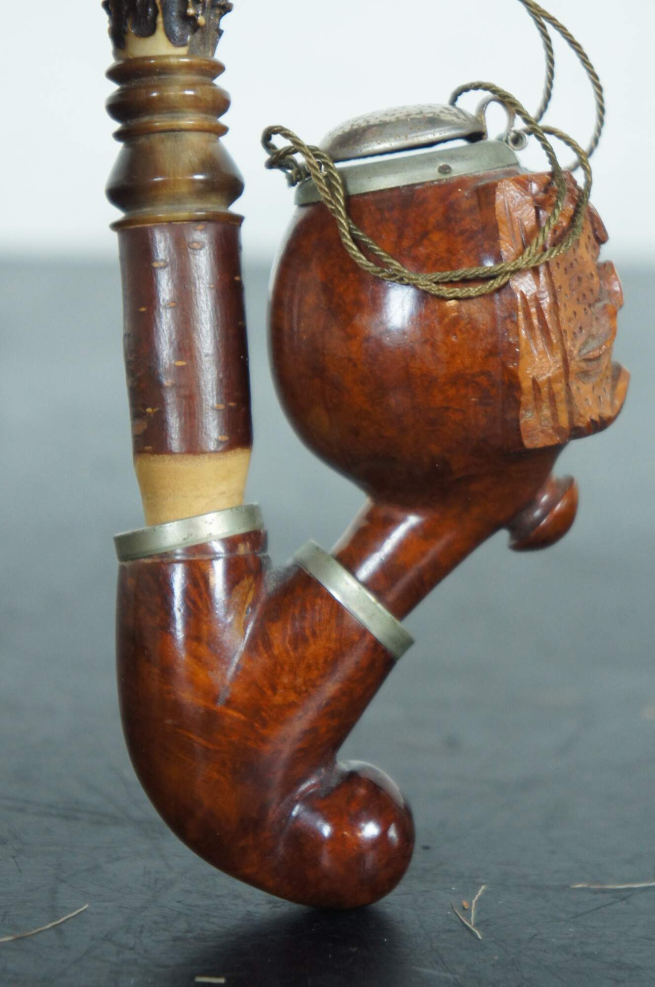 Briar wood tobacco pipe in the form of a German porcelain with carved bowl  and mount